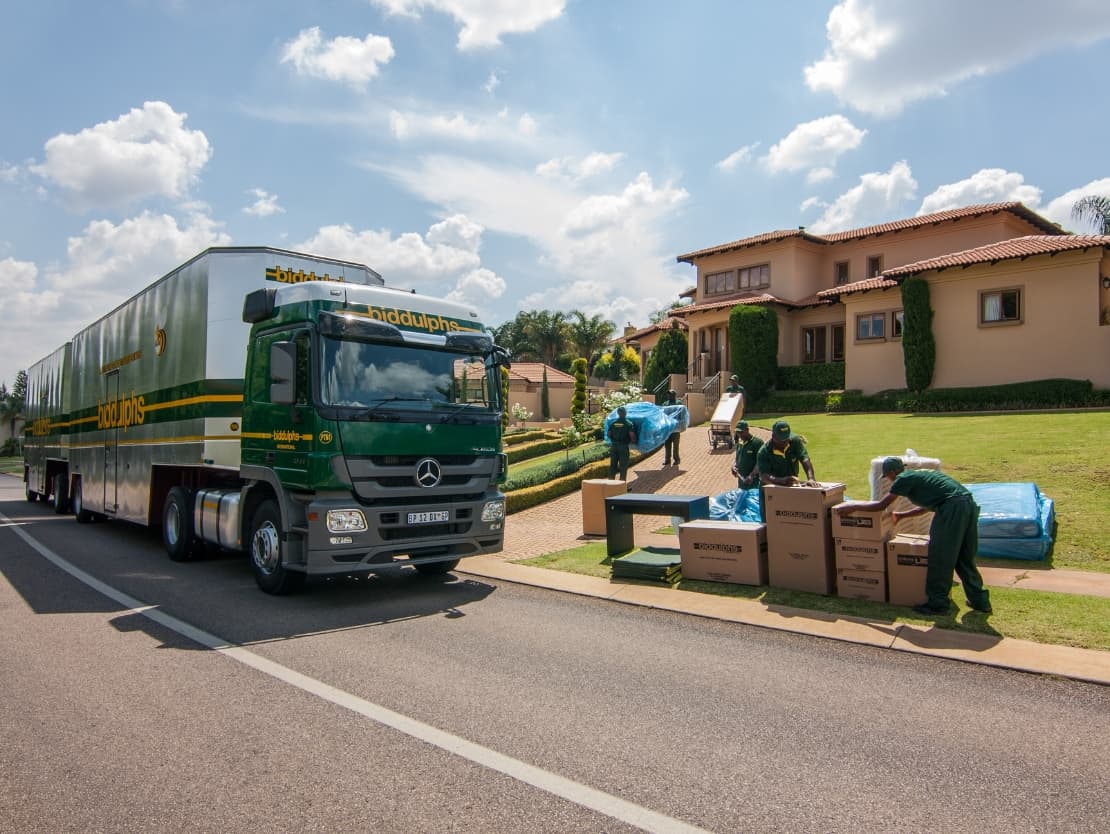 Biddulphs moving truck with workers loading furniture